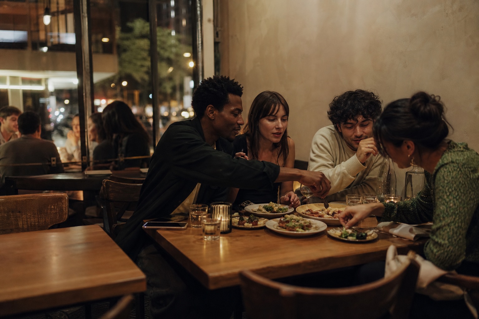 Friends sharing dishes around a table
