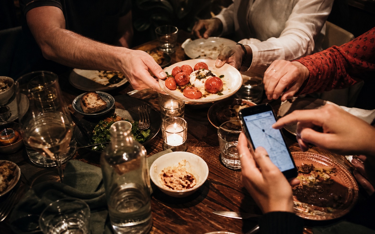 Friends passing plates around a shared table